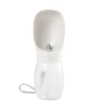 A white portable pet water bottle with a fold-out bowl design, a textured lower section, a gray nozzle, and a white wrist strap, shown on a plain white background.