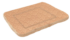 Dog lying on a beige pet bed with a white background