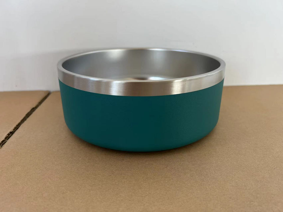 Teal bowl with silver rim on a cardboard surface