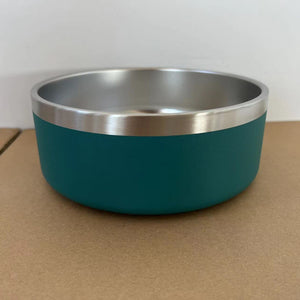 Teal bowl with silver rim on a brown surface