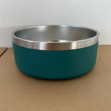 Teal bowl with silver rim on a brown surface