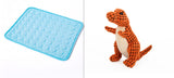 Blue textured mat on the left and orange dinosaur toy on the right.