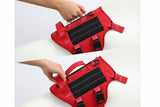 Red dog harness with handles for mobility assistance and canine control, on a white background.