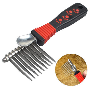 Pet grooming comb with red and black handle on a white background