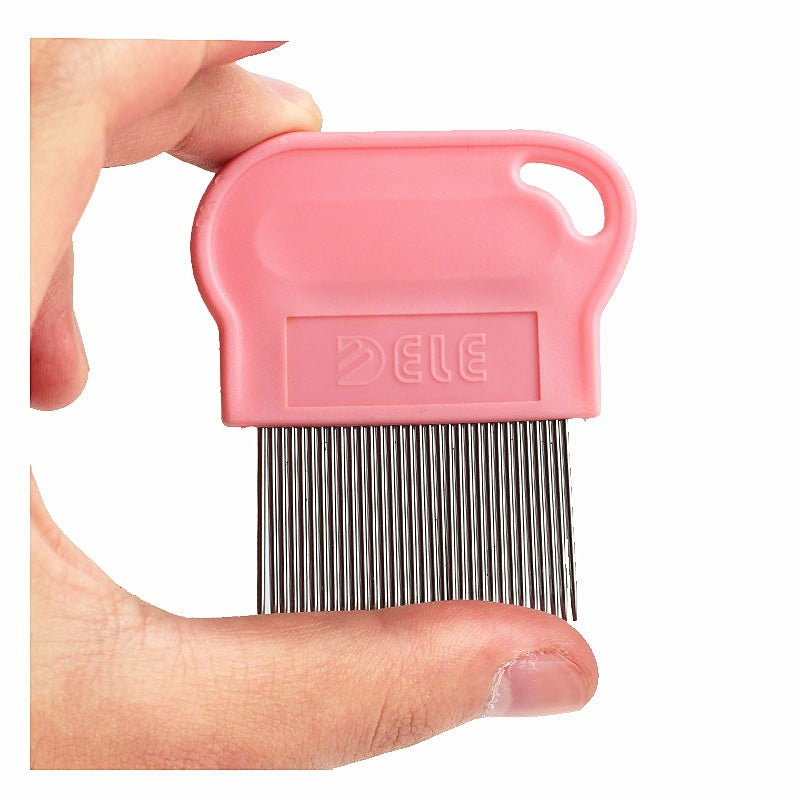 Pink pet grooming comb held between fingers on a white background