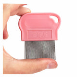 Pink pet grooming comb held between fingers on a white background