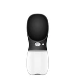 A modern pet water fountain with a black top section and a white bottom section, featuring a central button with a paw print icon and a small indicator light, set against a plain white background.