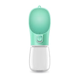 Portable pet water bottle with a green top and clear base on a white background
