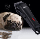 Dog grooming clipper next to a sleeping pug on a black background
