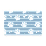 Pet mat with paw print and bone pattern on a blue striped background