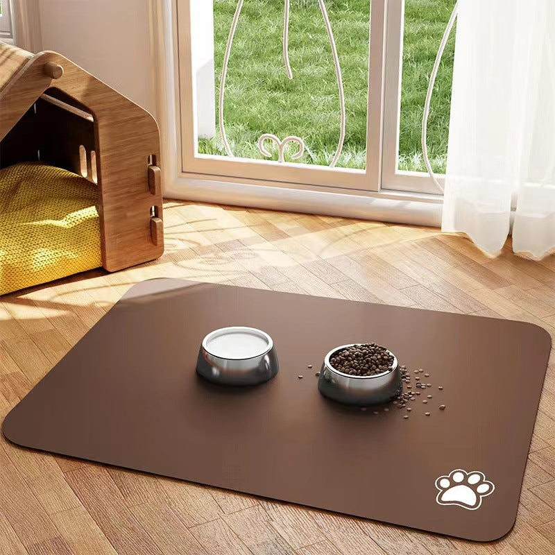 Pet feeding area with a large brown mat, two bowls, and a wooden pet house by a window.