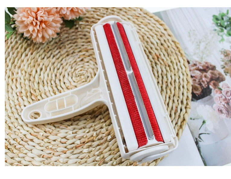 Cleaning tool with red bristles on a woven mat with flowers in the background