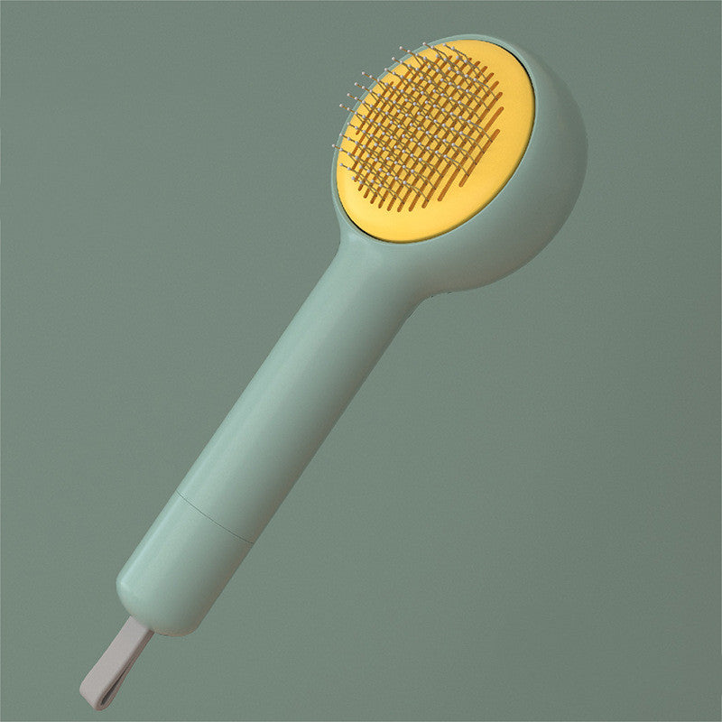 Gentle touch hairbrush with yellow bristle head and green handle on a gray background