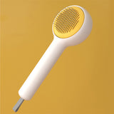 White handheld shower head with yellow nozzle on a mustard yellow background