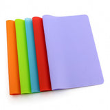 Set of colorful silicone mats on a white background