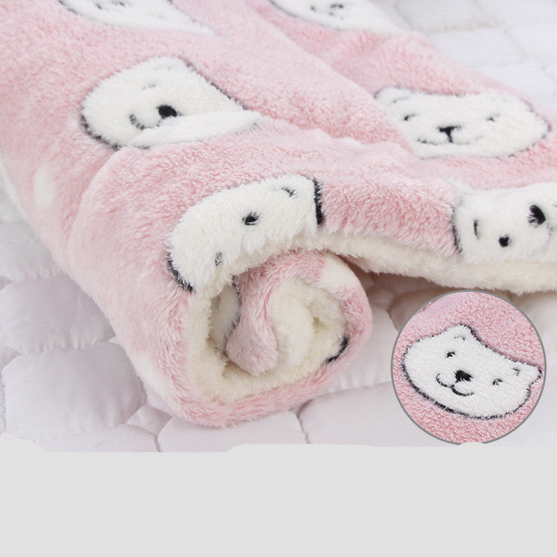 Pink plush blanket with teddy bear patterns on a white background