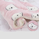 Pink plush blanket with teddy bear patterns on a white background