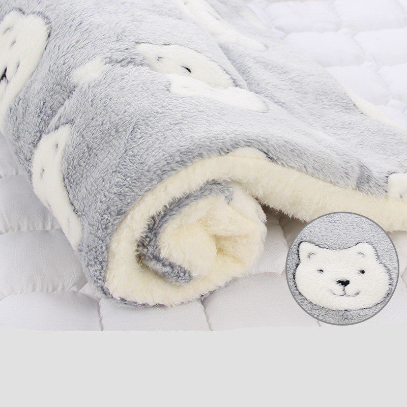 Folded gray and white blanket with a close-up of a polar bear face in the corner.