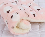 Fluffy pink blanket with brown spots on a white background