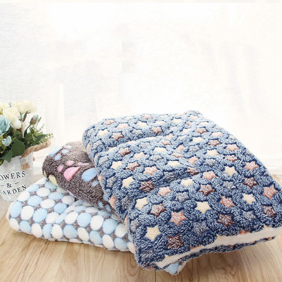 Fluffy blanket with star pattern on a wooden surface