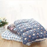 Fluffy blanket with star pattern on a wooden surface