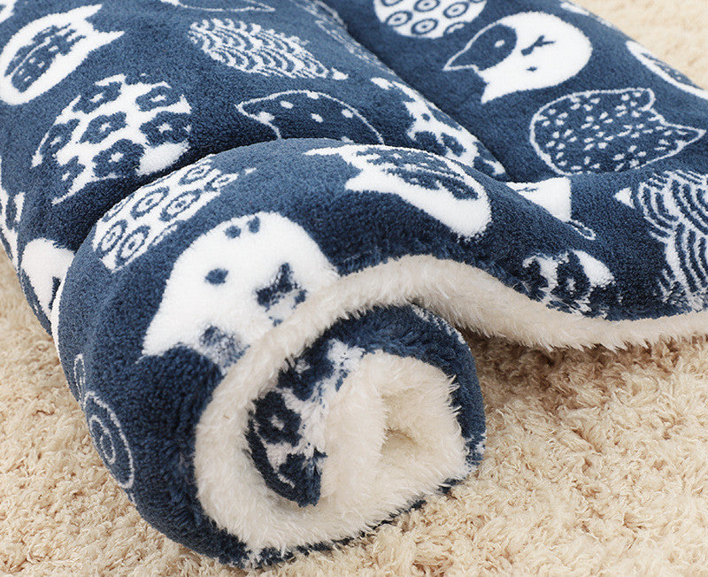 Blue and white patterned blanket with a fluffy texture on a beige surface
