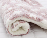 Roll of pink and white textured fabric on a white background