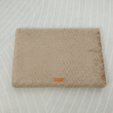 Beige textured blanket on a light gray background