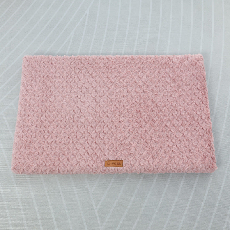 Pink textured mat with a brand logo on a light gray background
