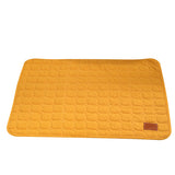 Yellow quilted mat with a brown leather patch on a white background