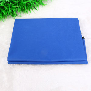 Folded red fabric on a white background with green grass on the side