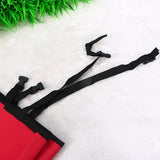 Red mat with black straps on a white surface with grass in the corner