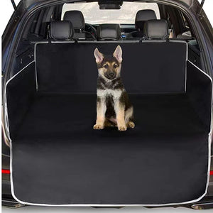 German Shepherd on a car bench cover with open car trunk