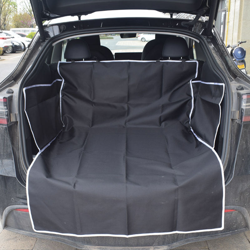 Car trunk with a black cargo liner covering the floor.