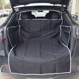 Car trunk with a black cargo liner covering the floor.