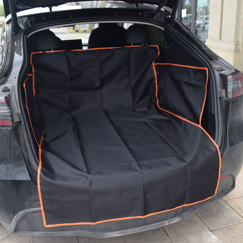 Car trunk with a black pet seat cover with orange trim