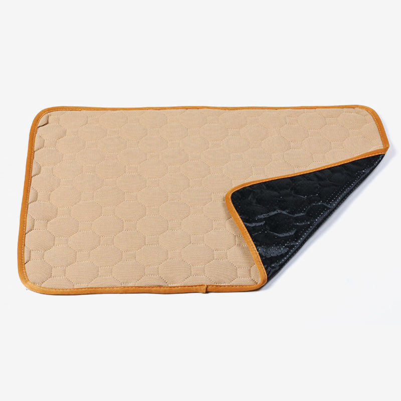 Beige and black quilted saddle pad on a white background