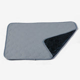Gray quilted mat with a textured pattern on a white background
