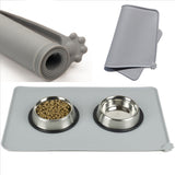 Gray silicone mat with two metal bowls containing pet food, rolled mat, and folded mat on a white background.
